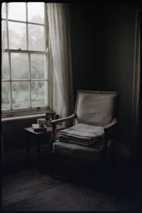 An armchair beside a misty window