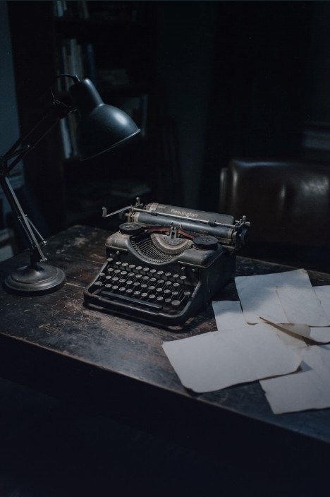 A vintage typewriter on a dark desk